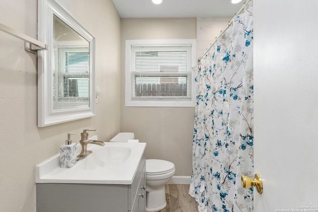 bathroom featuring hardwood / wood-style floors, vanity, toilet, and a shower with shower curtain