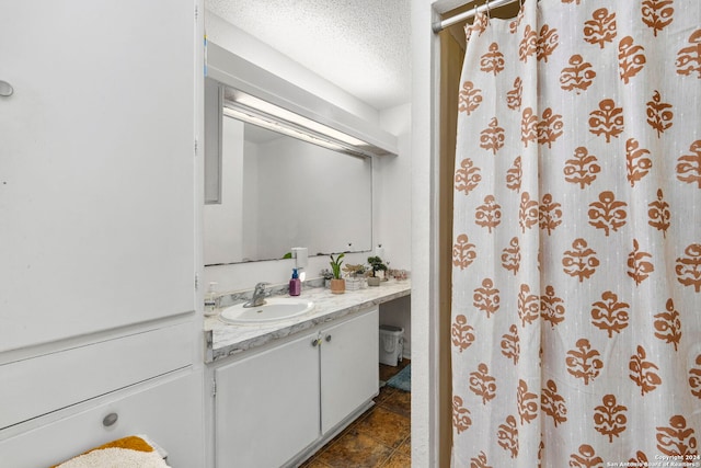 bathroom featuring vanity, a textured ceiling, and a shower with shower curtain