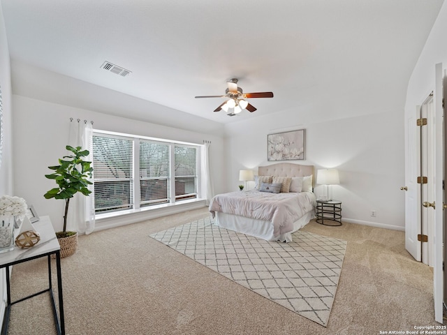 bedroom featuring light carpet, baseboards, visible vents, and a ceiling fan