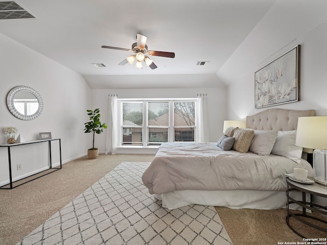 bedroom featuring lofted ceiling and visible vents