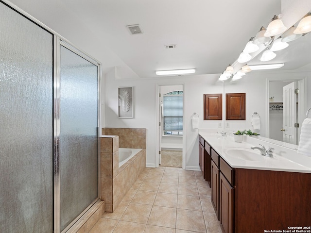 bathroom with tile patterned flooring, a sink, visible vents, and a shower stall