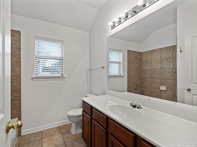 bathroom featuring baseboards, toilet, tile patterned flooring, vaulted ceiling, and vanity