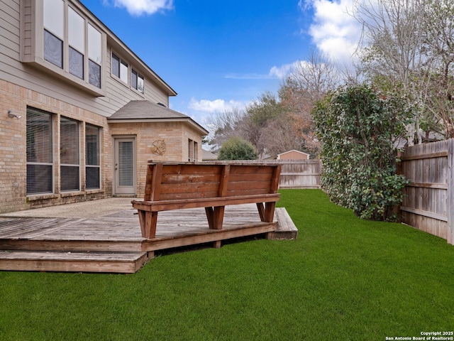 view of yard with a fenced backyard and a wooden deck