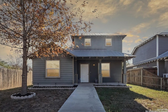 view of front of home with a lawn and a porch