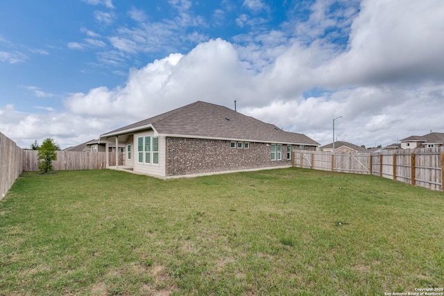 rear view of property with a lawn