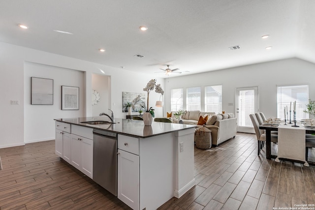 kitchen with white cabinetry, dishwasher, ceiling fan, sink, and a center island with sink