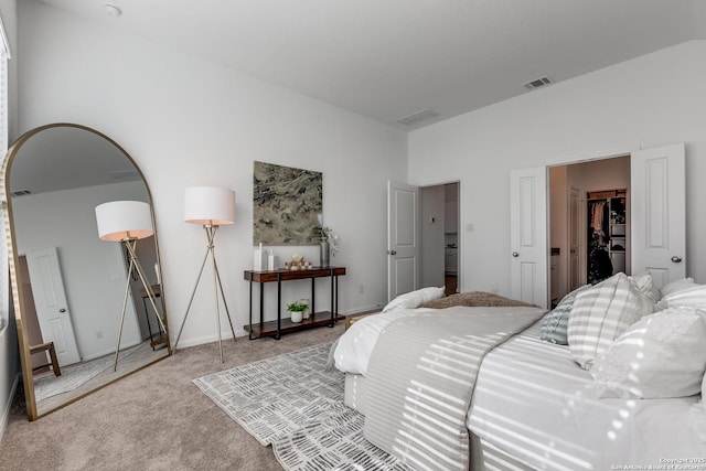 carpeted bedroom with a spacious closet and a closet