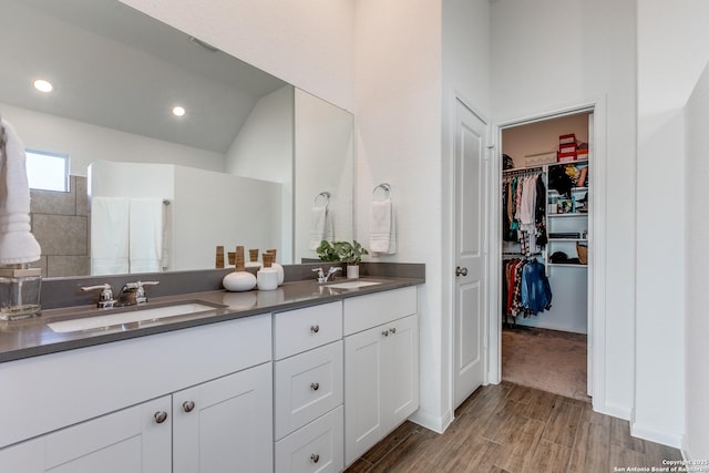 bathroom featuring vanity and lofted ceiling