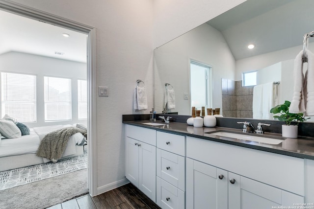 bathroom with vanity and lofted ceiling