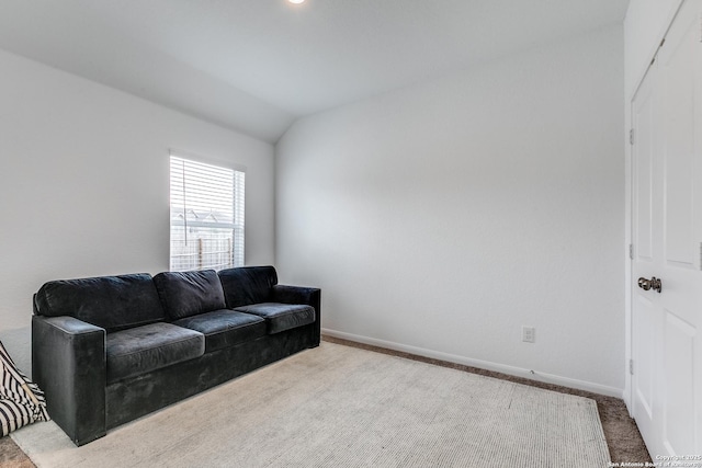 living room featuring carpet and vaulted ceiling