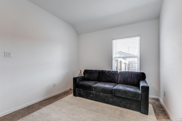 sitting room with light carpet and vaulted ceiling