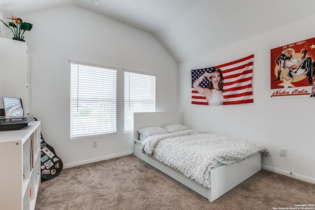 carpeted bedroom with lofted ceiling