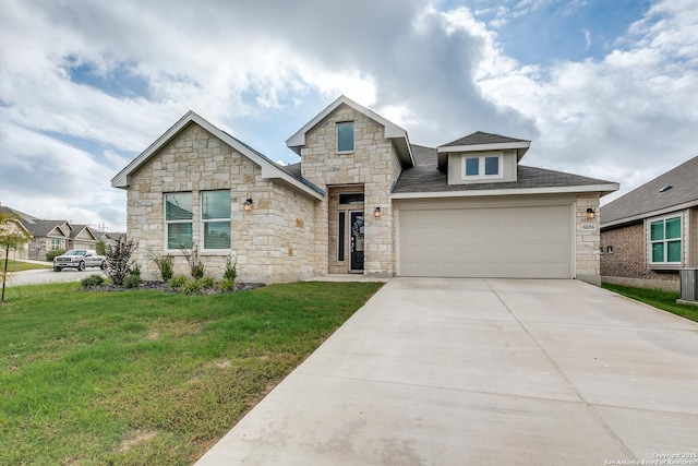 view of front facade with a front yard and a garage