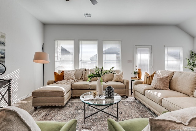 living room featuring ceiling fan, wood-type flooring, and lofted ceiling