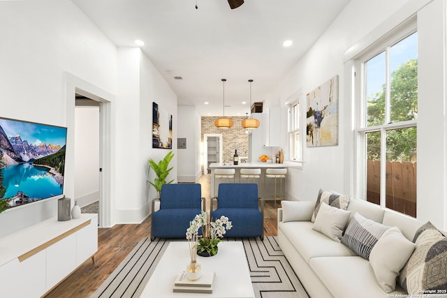 living room featuring dark hardwood / wood-style flooring and ceiling fan