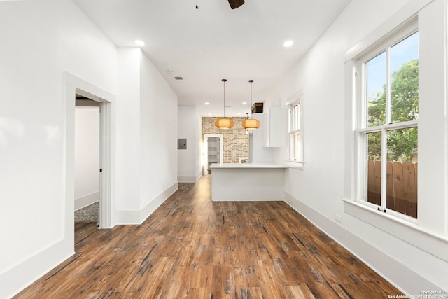 unfurnished living room with dark hardwood / wood-style floors and ceiling fan