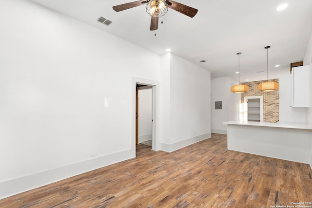 unfurnished living room featuring hardwood / wood-style floors and ceiling fan