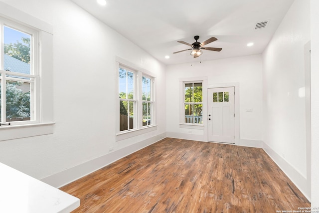 spare room with hardwood / wood-style flooring and ceiling fan