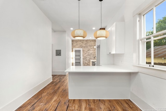 kitchen featuring white cabinets, plenty of natural light, and kitchen peninsula