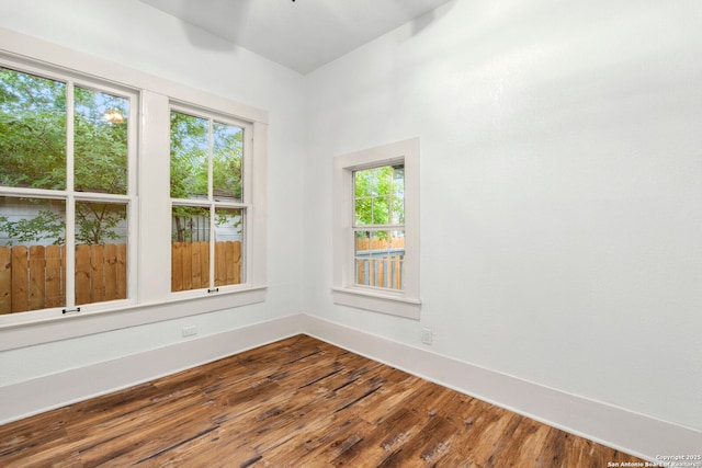 unfurnished room featuring hardwood / wood-style flooring