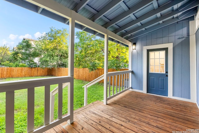 wooden deck featuring a lawn