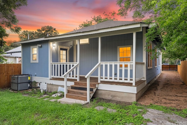 view of front facade featuring central AC unit and a porch