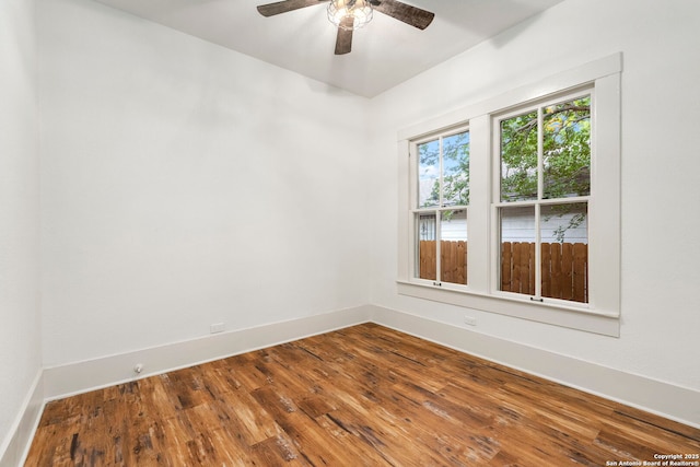 empty room featuring ceiling fan and hardwood / wood-style flooring