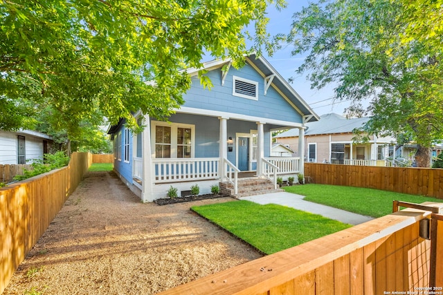 bungalow-style house with a front yard and a porch