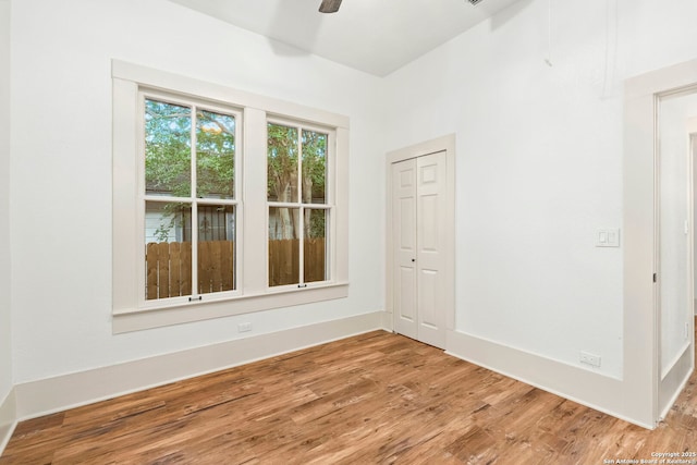 unfurnished room with ceiling fan and wood-type flooring