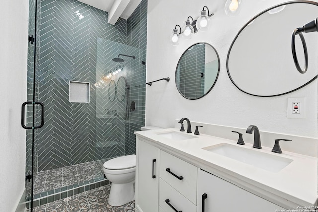 bathroom featuring tile patterned floors, vanity, toilet, and a shower with door