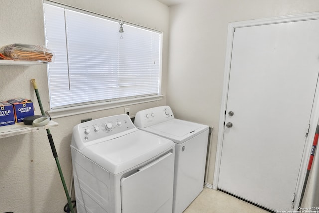 washroom featuring washer and clothes dryer