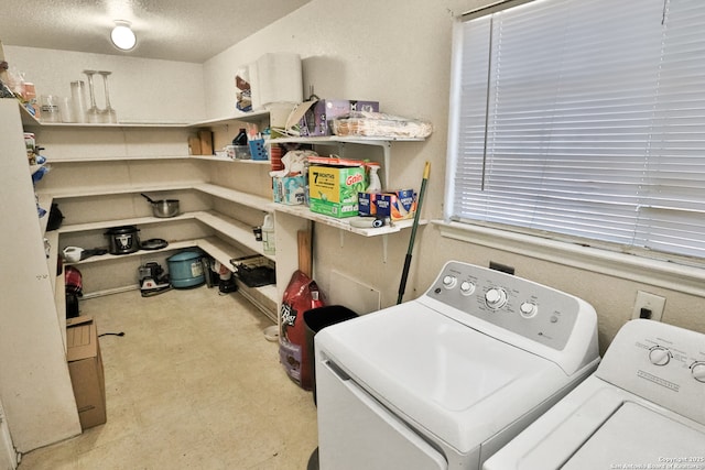 washroom featuring washing machine and dryer and a textured ceiling