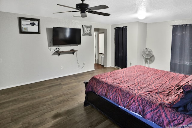 bedroom featuring ceiling fan, dark hardwood / wood-style flooring, and a textured ceiling