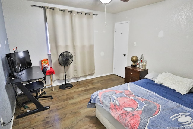 bedroom with ceiling fan and wood-type flooring