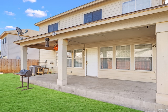 rear view of house featuring central AC, a yard, and a patio