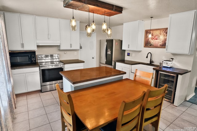 kitchen with wine cooler, white cabinetry, pendant lighting, and stainless steel appliances