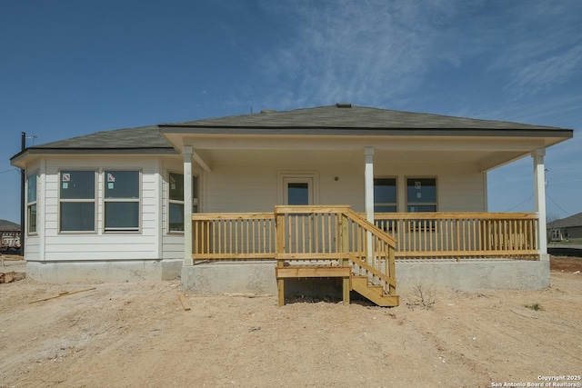 rear view of house featuring a porch