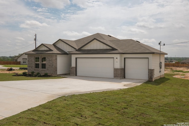 view of front of house featuring concrete driveway, a front yard, brick siding, and a garage
