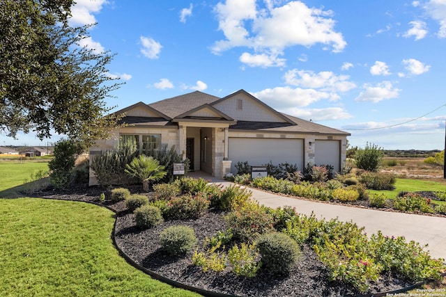 view of front facade with a front yard and a garage