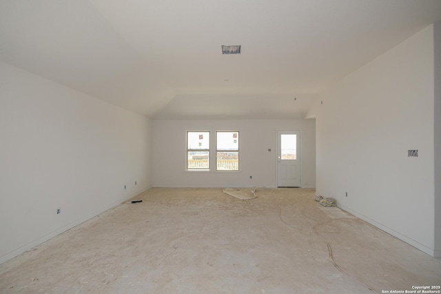 spare room with lofted ceiling