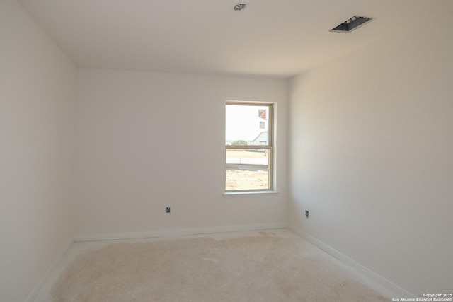 unfurnished room with baseboards