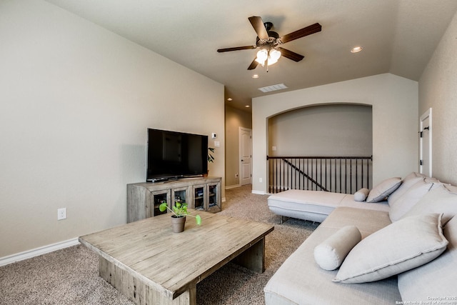 living room with ceiling fan, carpet floors, and vaulted ceiling