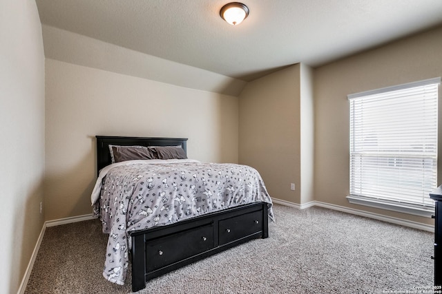 carpeted bedroom with multiple windows and lofted ceiling