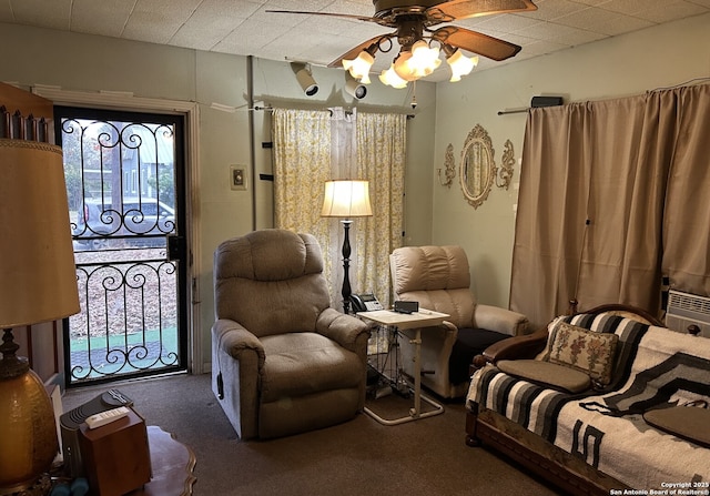 sitting room featuring ceiling fan and carpet