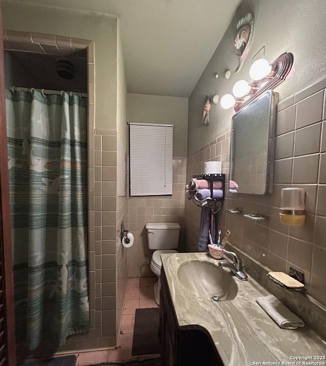 bathroom featuring toilet, tile walls, tile patterned floors, vanity, and curtained shower