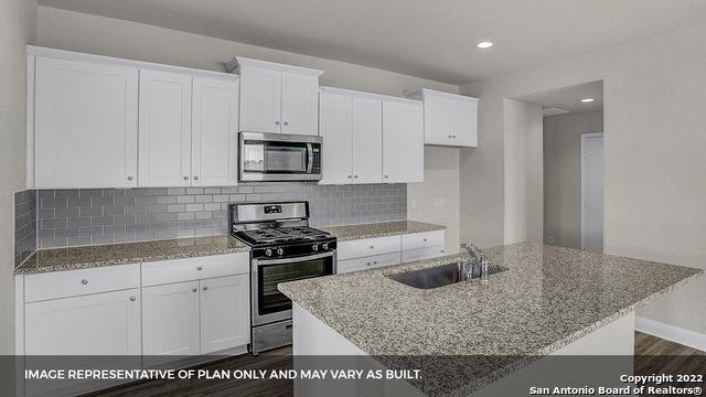 21070 Watercourse Way, San Antonio, TX 78266 - kitchen featuring appliances with stainless steel finishes, white cabinetry, and sink