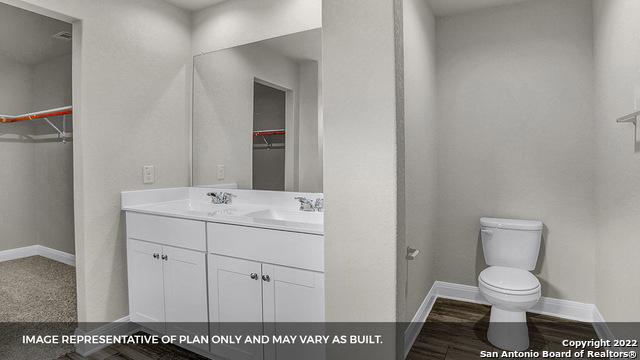 21070 Watercourse Way, San Antonio, TX 78266 - bathroom featuring vanity and toilet