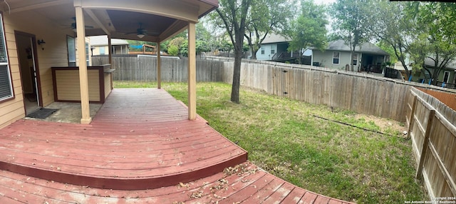 deck with ceiling fan and a yard