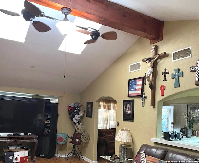 living room with hardwood / wood-style flooring, ceiling fan, and vaulted ceiling