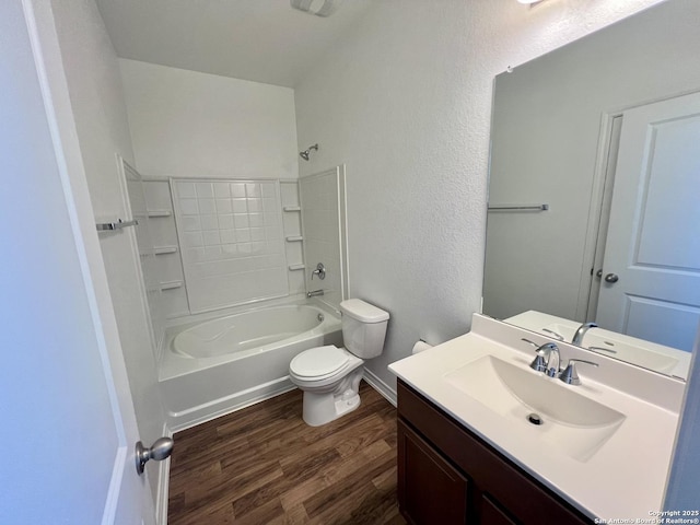 full bathroom with hardwood / wood-style flooring, vanity,  shower combination, and toilet